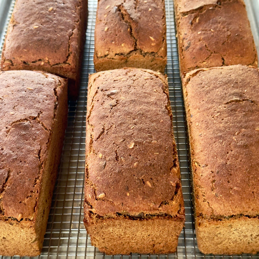 Six loaves of bread on a cooling rack